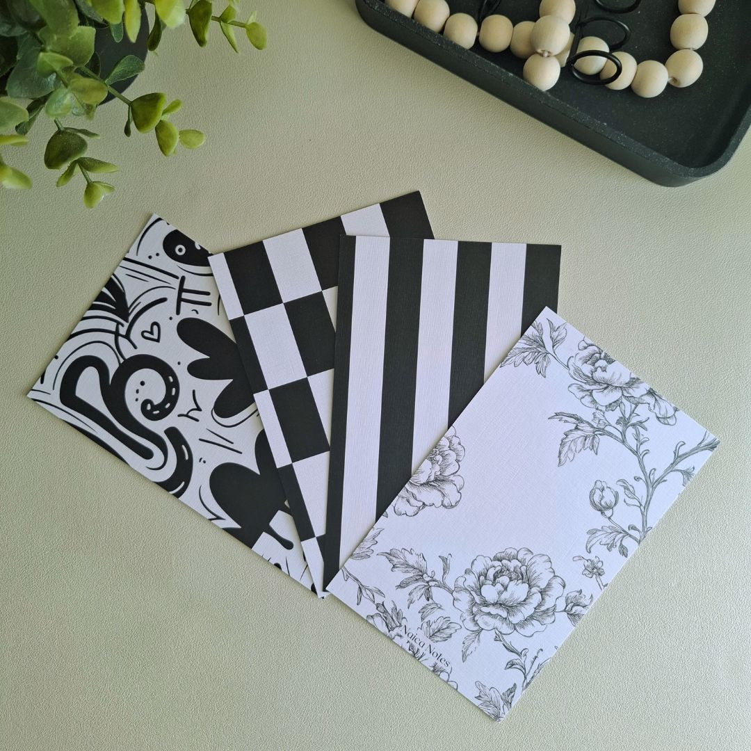 Vier linnen dashboards uit de Black and White collectie – Chic Tiles, Bold Stripes, Romantic Floral en Playful Abstract samen getoond